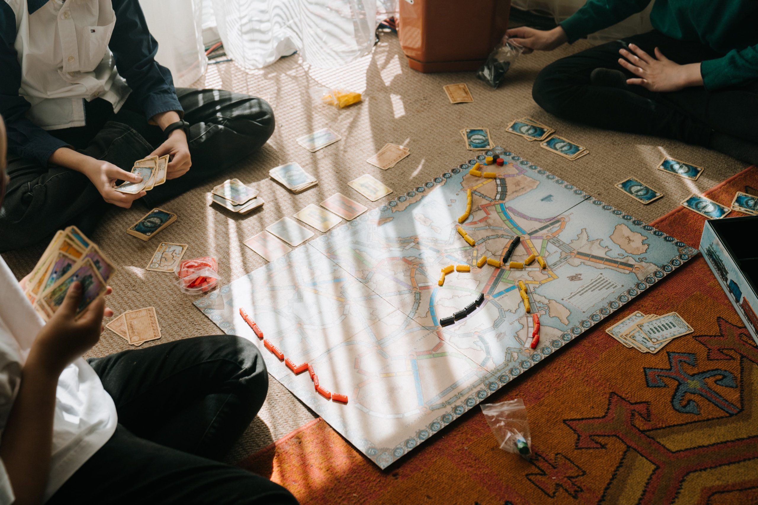 Family members game cards holding cards and playing board game